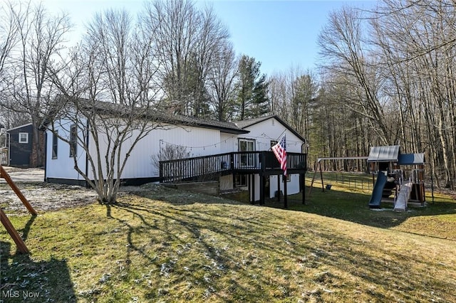 view of yard with a wooden deck and a playground