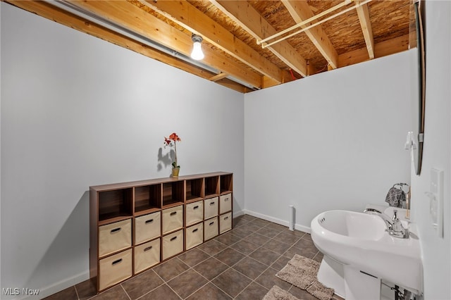 bathroom with tile patterned floors, baseboards, and a sink