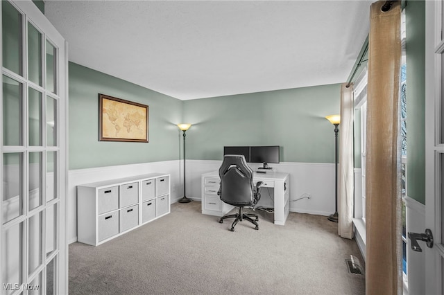 home office with visible vents and carpet floors