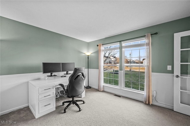 office space featuring visible vents and light colored carpet