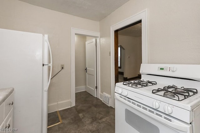 kitchen with visible vents, white cabinetry, white appliances, light countertops, and baseboards