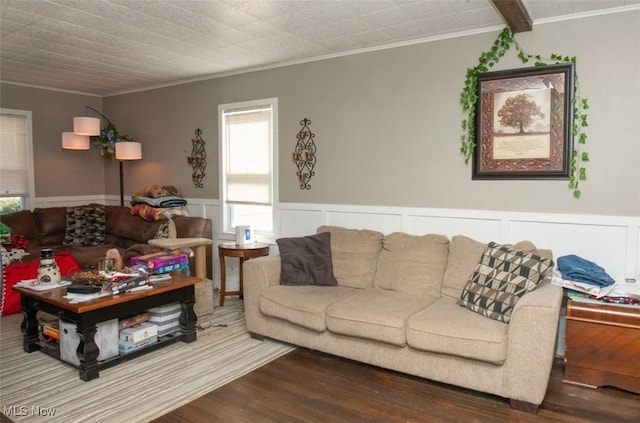 living area featuring a wainscoted wall, ornamental molding, and wood finished floors