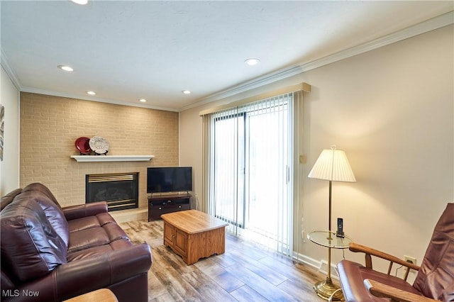 living area with light wood finished floors, baseboards, ornamental molding, recessed lighting, and a fireplace