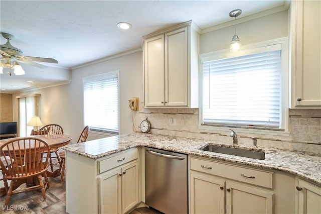 kitchen with crown molding, a peninsula, stainless steel dishwasher, cream cabinetry, and a sink