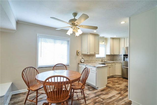 kitchen featuring tasteful backsplash, stainless steel fridge, dark wood-type flooring, and a sink