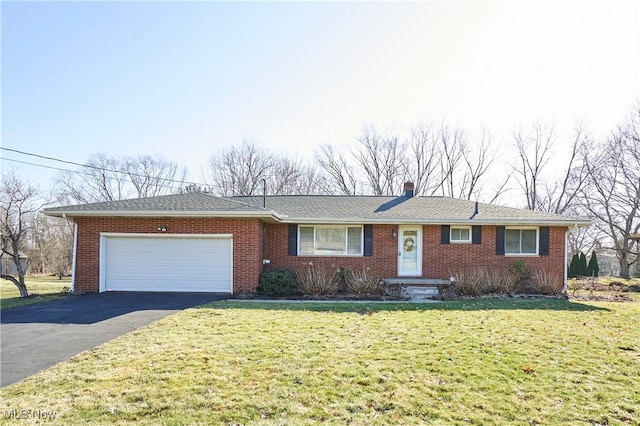 ranch-style home with brick siding, an attached garage, a front yard, a chimney, and driveway