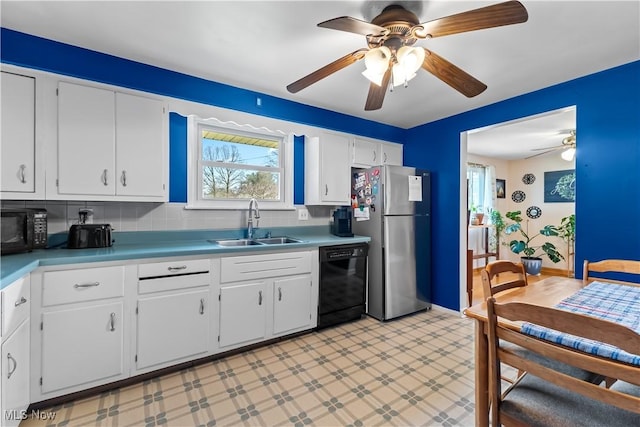 kitchen with light floors, a sink, black appliances, white cabinets, and light countertops