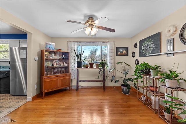 interior space featuring a wealth of natural light, light wood finished floors, and baseboards