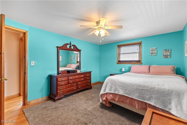 bedroom featuring baseboards and ceiling fan