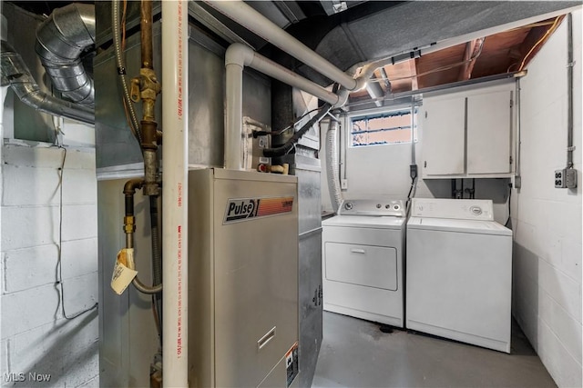 washroom with cabinet space and washer and dryer