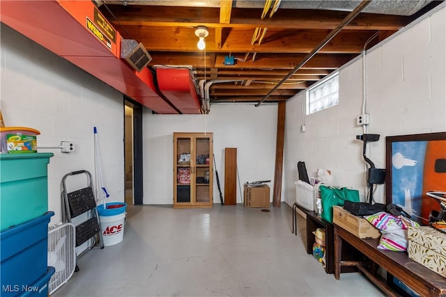 basement featuring visible vents and concrete block wall