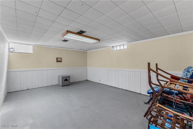 basement featuring a wainscoted wall and visible vents