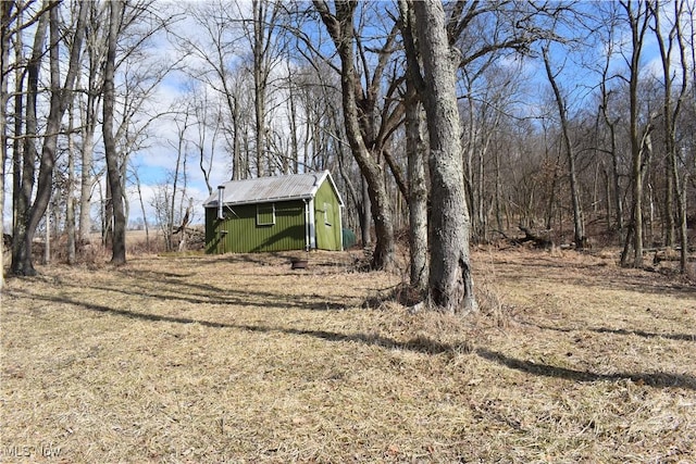 view of yard featuring a storage unit and an outbuilding