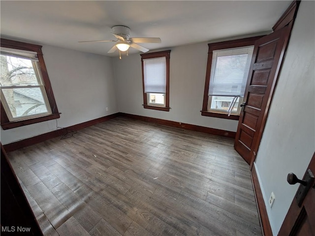 unfurnished bedroom with cooling unit, baseboards, wood finished floors, and a ceiling fan