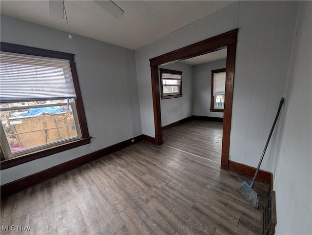 empty room featuring baseboards and wood finished floors