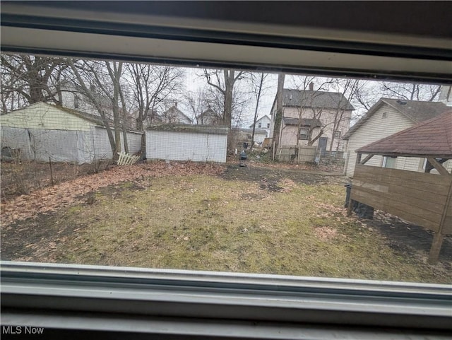 view of yard featuring an outdoor structure and fence