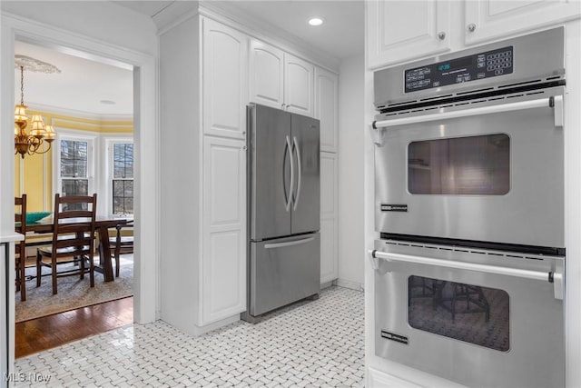 3006 Kingsley Rd, Shaker Heights, OH 44122 - kitchen featuring ornamental molding, white cabinetry, recessed lighting, appliances with stainless steel finishes, and a chandelier