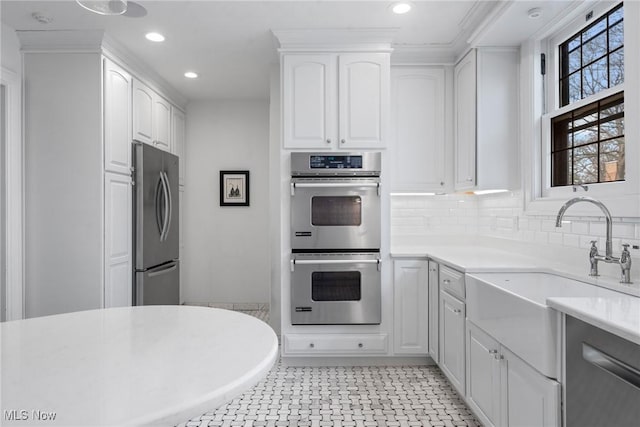 3006 Kingsley Rd, Shaker Heights, OH 44122 - kitchen featuring a sink, appliances with stainless steel finishes, white cabinets, and light countertops