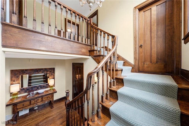 3006 Kingsley Rd, Shaker Heights, OH 44122 - stairs featuring an inviting chandelier, baseboards, and wood finished floors