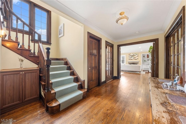 entrance foyer with stairway, ornamental molding, and hardwood / wood-style floors