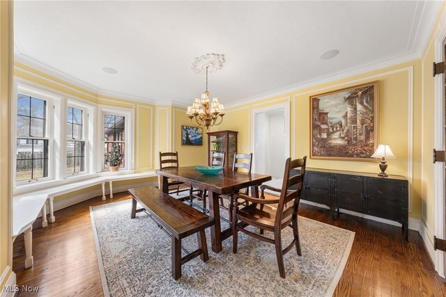 3006 Kingsley Rd, Shaker Heights, OH 44122 - dining room with dark wood finished floors, an inviting chandelier, and ornamental molding