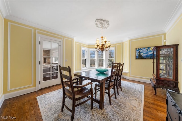 3006 Kingsley Rd, Shaker Heights, OH 44122 - dining area featuring crown molding, wood finished floors, and a chandelier