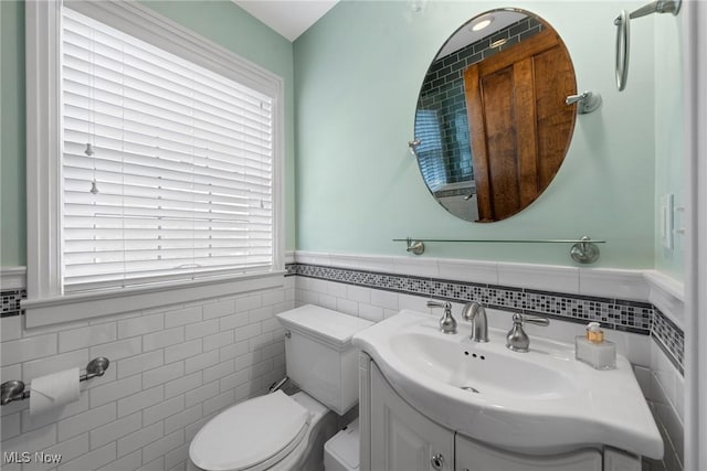 3006 Kingsley Rd, Shaker Heights, OH 44122 - half bath with a wainscoted wall, toilet, tile walls, and vanity