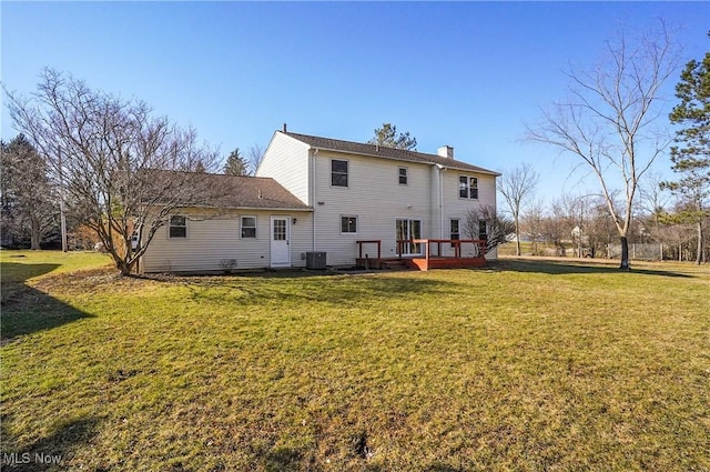 back of house with a yard, central AC, a deck, and a chimney