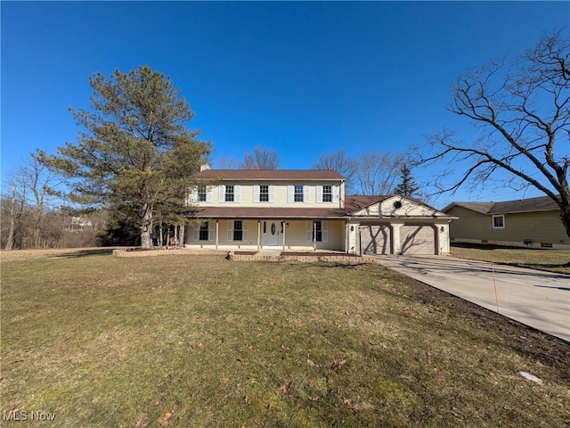 view of front of house featuring a front yard, a porch, a garage, and driveway