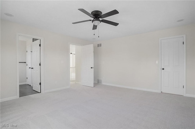 unfurnished bedroom with visible vents, a ceiling fan, baseboards, and carpet floors