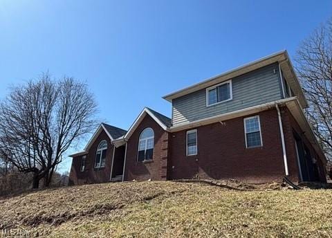 rear view of house with brick siding