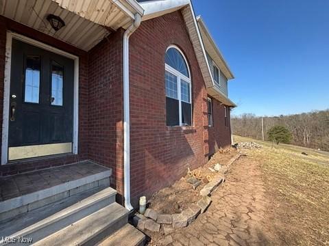 exterior space with brick siding