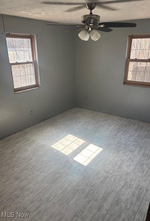 unfurnished room with wood finished floors and a textured ceiling