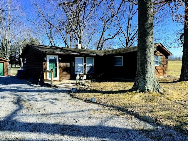 ranch-style house with gravel driveway