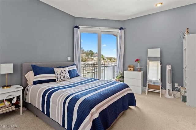 bedroom with access to exterior and carpet