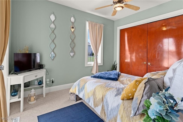 carpeted bedroom featuring a ceiling fan, baseboards, and a closet