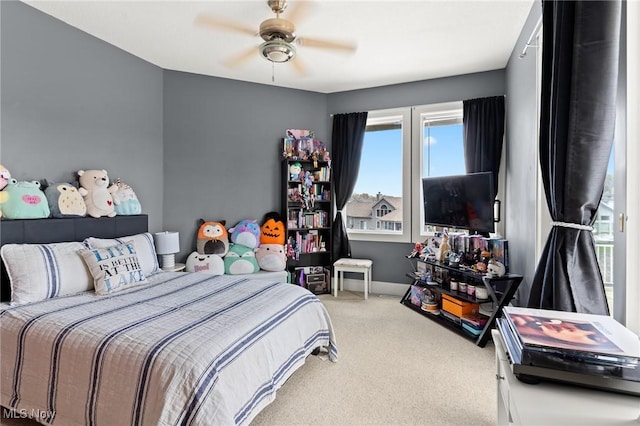 carpeted bedroom with baseboards and ceiling fan