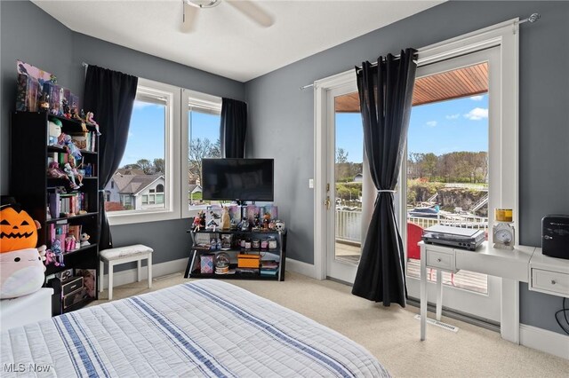 bedroom featuring access to exterior, multiple windows, baseboards, and carpet floors