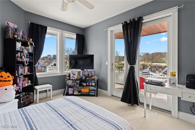 bedroom with baseboards, multiple windows, carpet, and access to outside