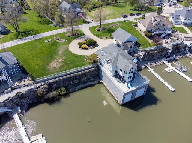 drone / aerial view featuring a water view and a residential view