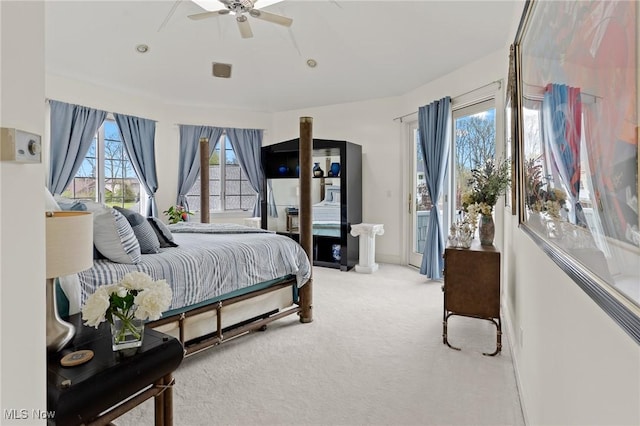 carpeted bedroom with access to exterior, baseboards, and a ceiling fan