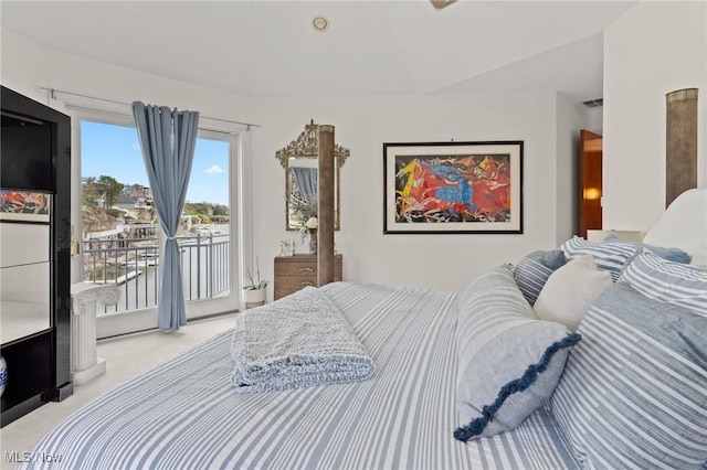 bedroom with access to exterior, light colored carpet, and visible vents