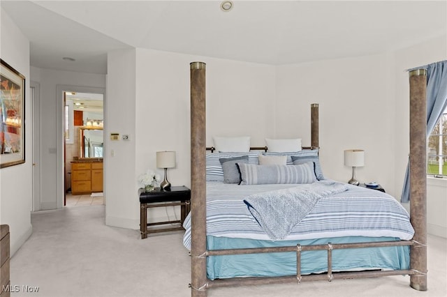 bedroom with light colored carpet and baseboards