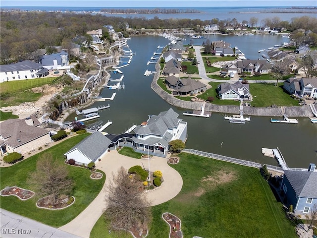 drone / aerial view with a residential view and a water view