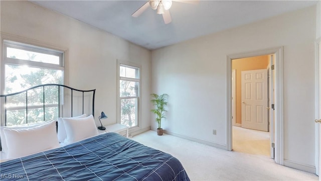 carpeted bedroom featuring a ceiling fan and baseboards