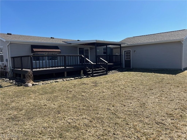 back of property featuring a deck and a yard