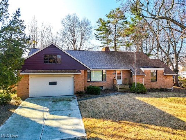 view of front of house with roof with shingles, brick siding, driveway, and a chimney