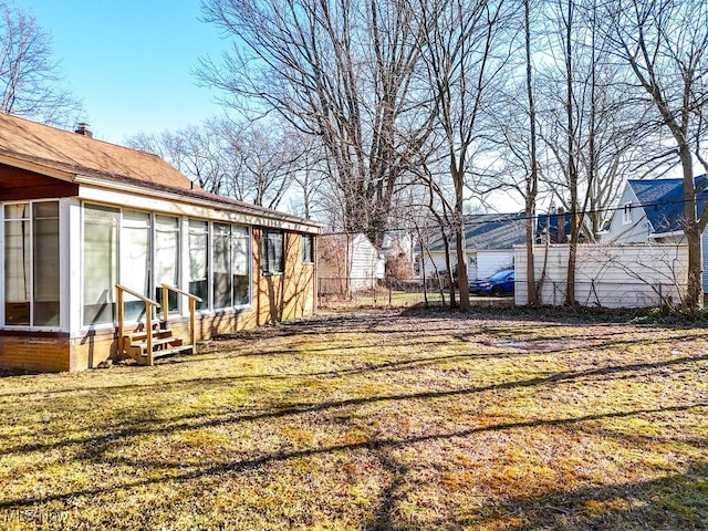 view of yard with entry steps and fence