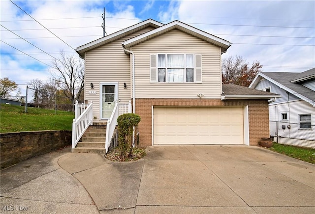 1833 29th St NW, Canton, OH 44709 - split level home with a garage, brick siding, and driveway