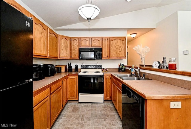 kitchen featuring lofted ceiling, brown cabinets, a peninsula, black appliances, and a sink